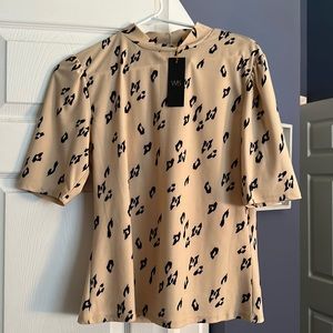 New with tags black and tan blouse.